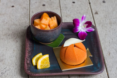 Close-up of dessert with fruit on tray at table