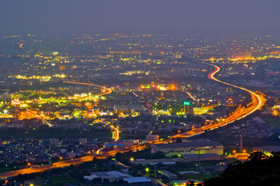 High angle view of illuminated buildings in city at night