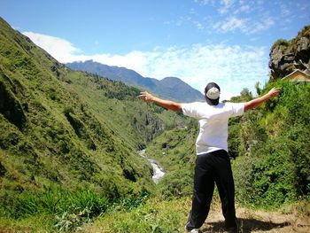 Full length of woman standing on mountain landscape