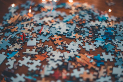 High angle view of multi colored puzzle pieces on table