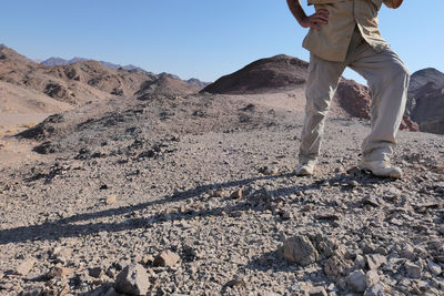 Low section of senior man walking in the desert 