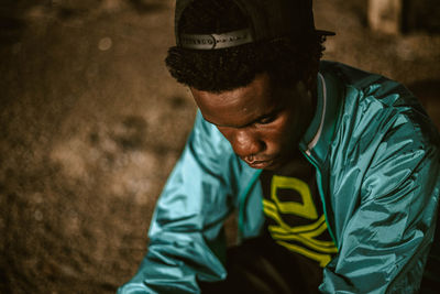 Young man sitting in building