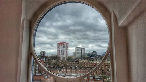 Cityscape against cloudy sky