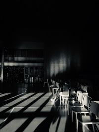 Empty chairs and tables in building
