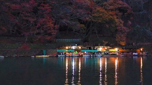 Boats moored in lake at night