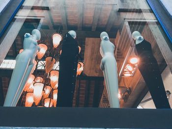 Low angle view of illuminated lighting equipment at store