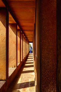 Rear view of man walking on bridge