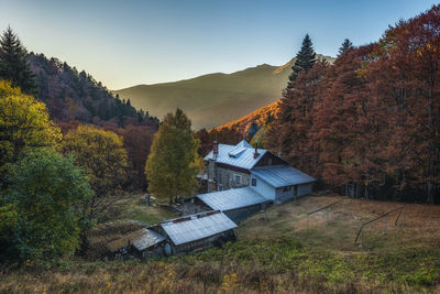 Panoramic view of trees and houses against sky