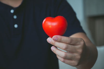 Close-up of woman holding heart shape