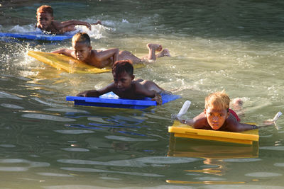 Friends floating on water at water park