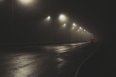 Illuminated road at night during winter