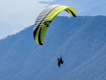 People paragliding against sky