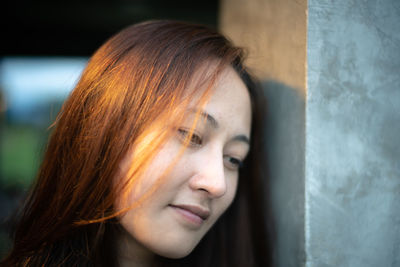 Close-up portrait of young woman looking away