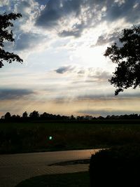 Scenic view of field against sky during sunset