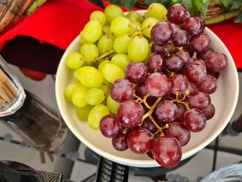 High angle view of grapes in bowl on table