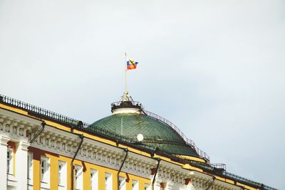 Low angle view of flags against clear sky