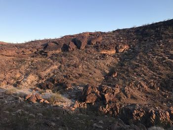 Rock formations on landscape against clear sky