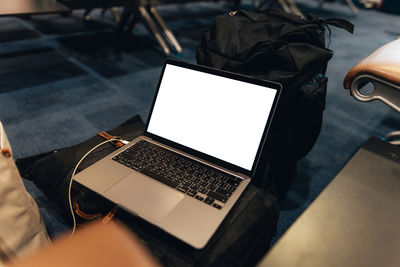 Midsection of woman using laptop on table