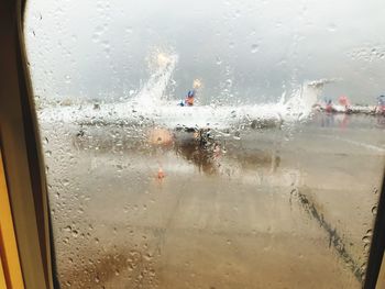 Close-up of wet glass window in rainy season