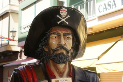 Close-up portrait of mid adult man standing in front of building