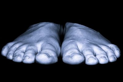 Close-up of hands over black background