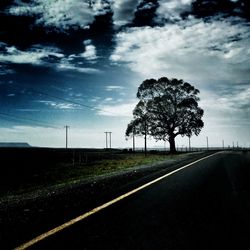 Empty road passing through field