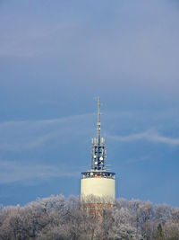 Low angle view of communications tower against sky