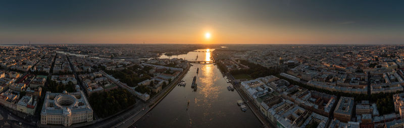 High angle view of illuminated cityscape against sky during sunset