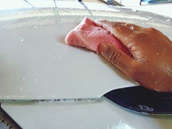 Close-up of person hand in container