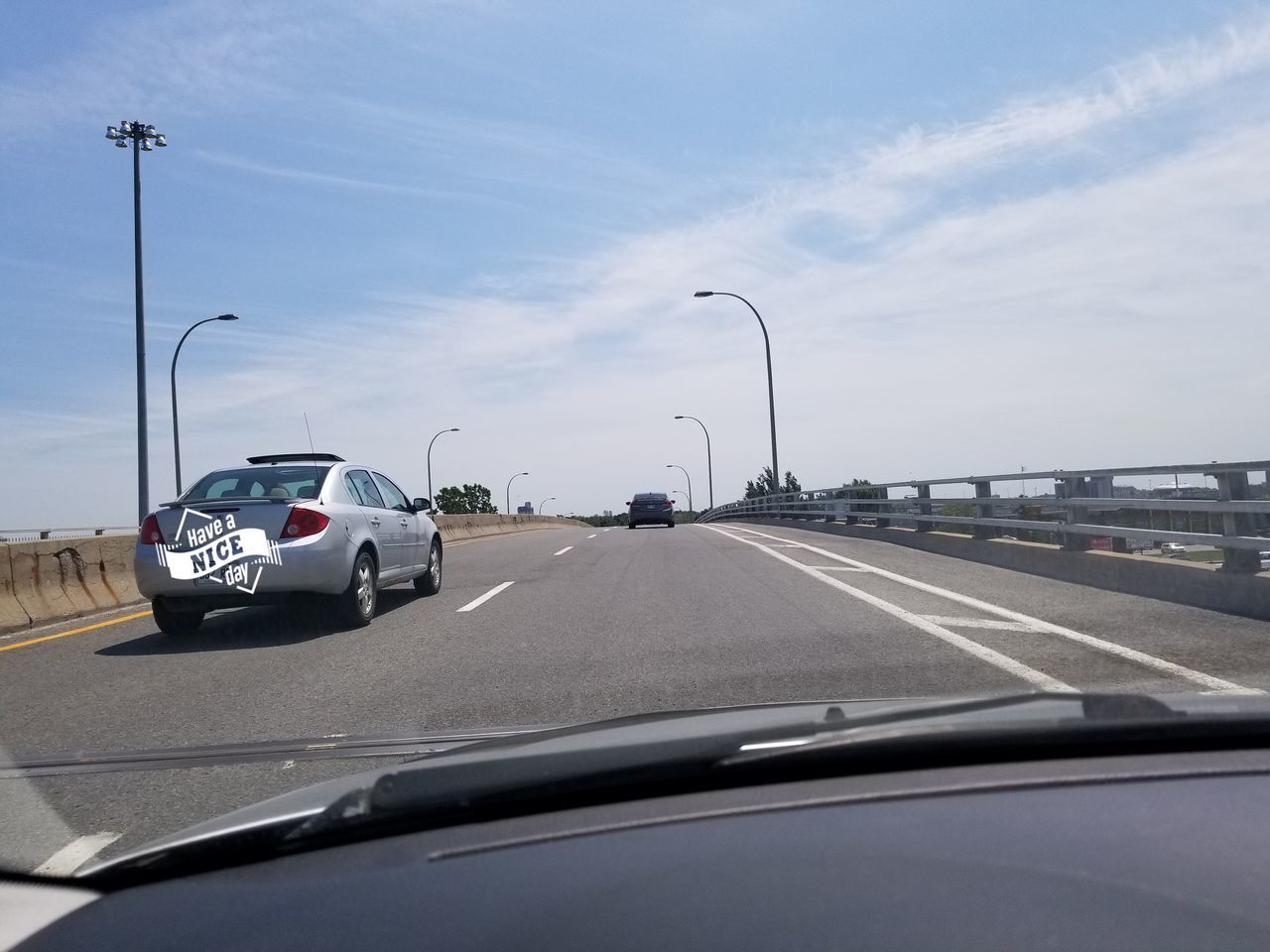 VEHICLES ON ROAD SEEN THROUGH CAR WINDSHIELD