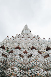 Low angle view of sculpture on building against sky