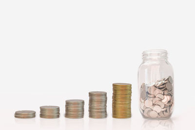 Stack of coins on table against white background