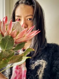 Close-up of asian woman with pink king protea flower.