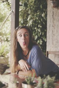 Portrait of young woman sitting outdoors