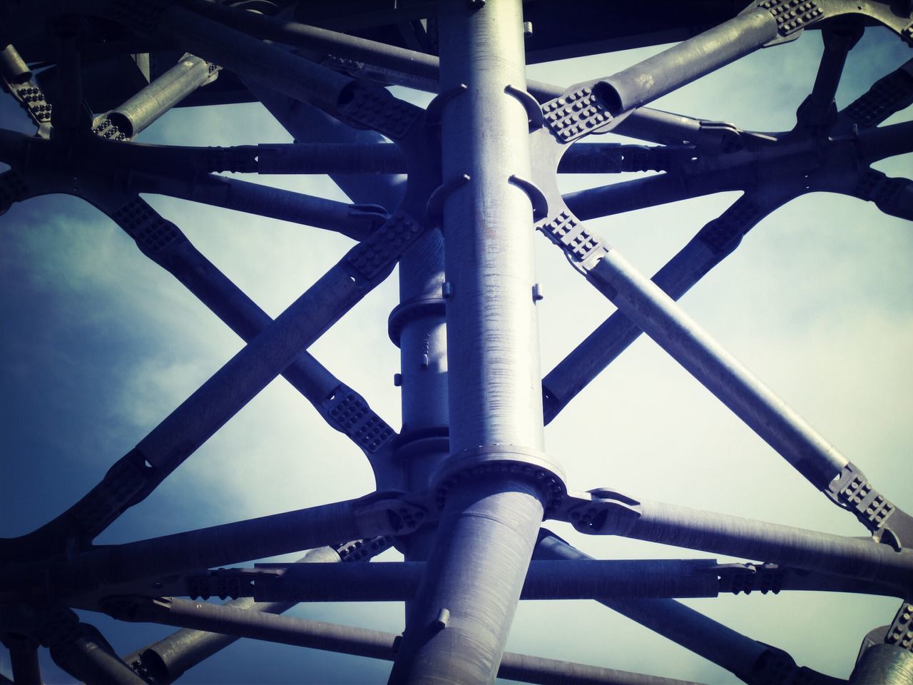 metal, metallic, low angle view, connection, sky, engineering, rusty, iron - metal, strength, bridge - man made structure, built structure, no people, outdoors, day, support, transportation, industry, close-up, safety, protection