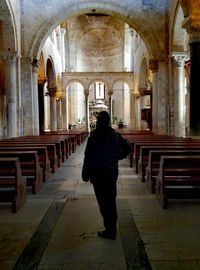 Rear view of a man walking in corridor