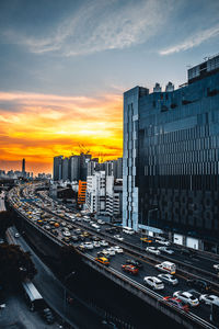 High angle view of city buildings against sky during sunset