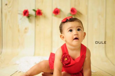 Close-up of cute baby girl sitting outdoors