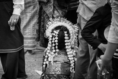 Low section of people standing on cross