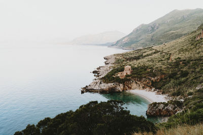 Scenic view of sea and mountains against sky