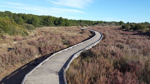 Road passing through landscape against sky