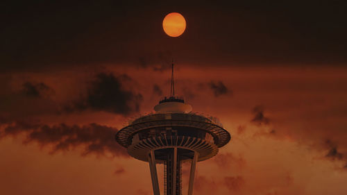 Low angle view of communications tower during sunset