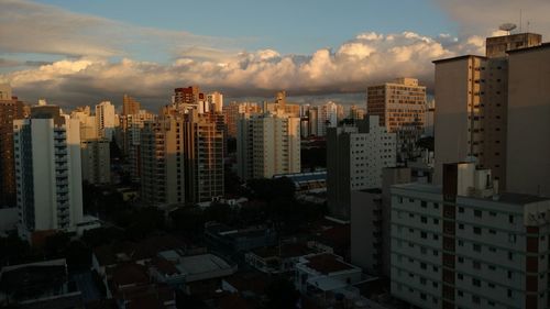 Aerial view of buildings in city against sky