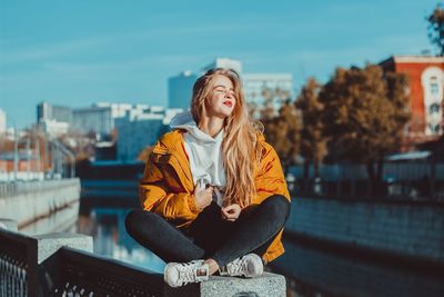 Young woman sitting outdoors