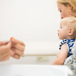 Close-up of boy holding baby girl at home