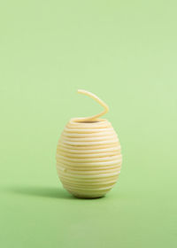 Close-up of vase against yellow background