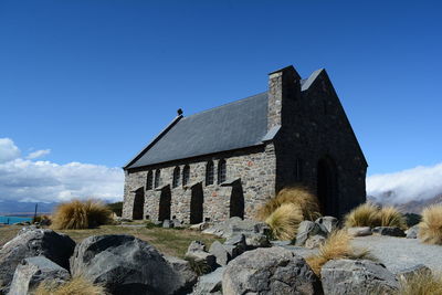 Low angle view of historic building against blue sky