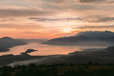 Scenic view of silhouette mountains against sky at sunset