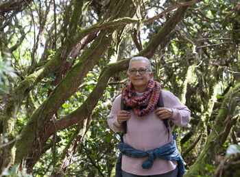 Portrait of a smiling young man in forest