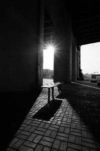 Sunlight falling on street amidst buildings in city